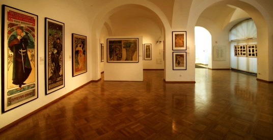 Interior view of the Mucha Museum with advertising posters