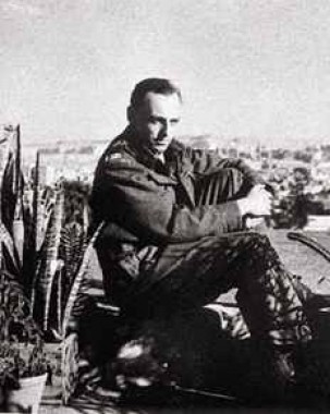 Jiří Mucha Jiří sitting on a rock with view of a city behind