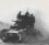 The battle of Belchev Tank emerging from dust