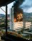 A Bosnia and Herzegovina government building in the centre of Sarajevo burns after being hit by tank A high rise building in flames with smoke bellowing from the top two thirds