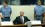 Slobodan Milosevic on trial in the Hague Court Milosevic sits in a defiant pose with two court room employees standing either side of him