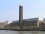 A view of the Tate Modern in London from the River Thames A large brick building with a tall white tower in the centre with the river Thames in front