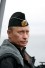 Vladimir Putin on the board of the heavy nuclear cruiser Peter the Great during the military exercis Head and shoulders portrait of Vladimir Putin in military uniform with the sea behind