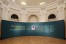 View of circular room with a large text panel introducing the exhibition in Czech and English